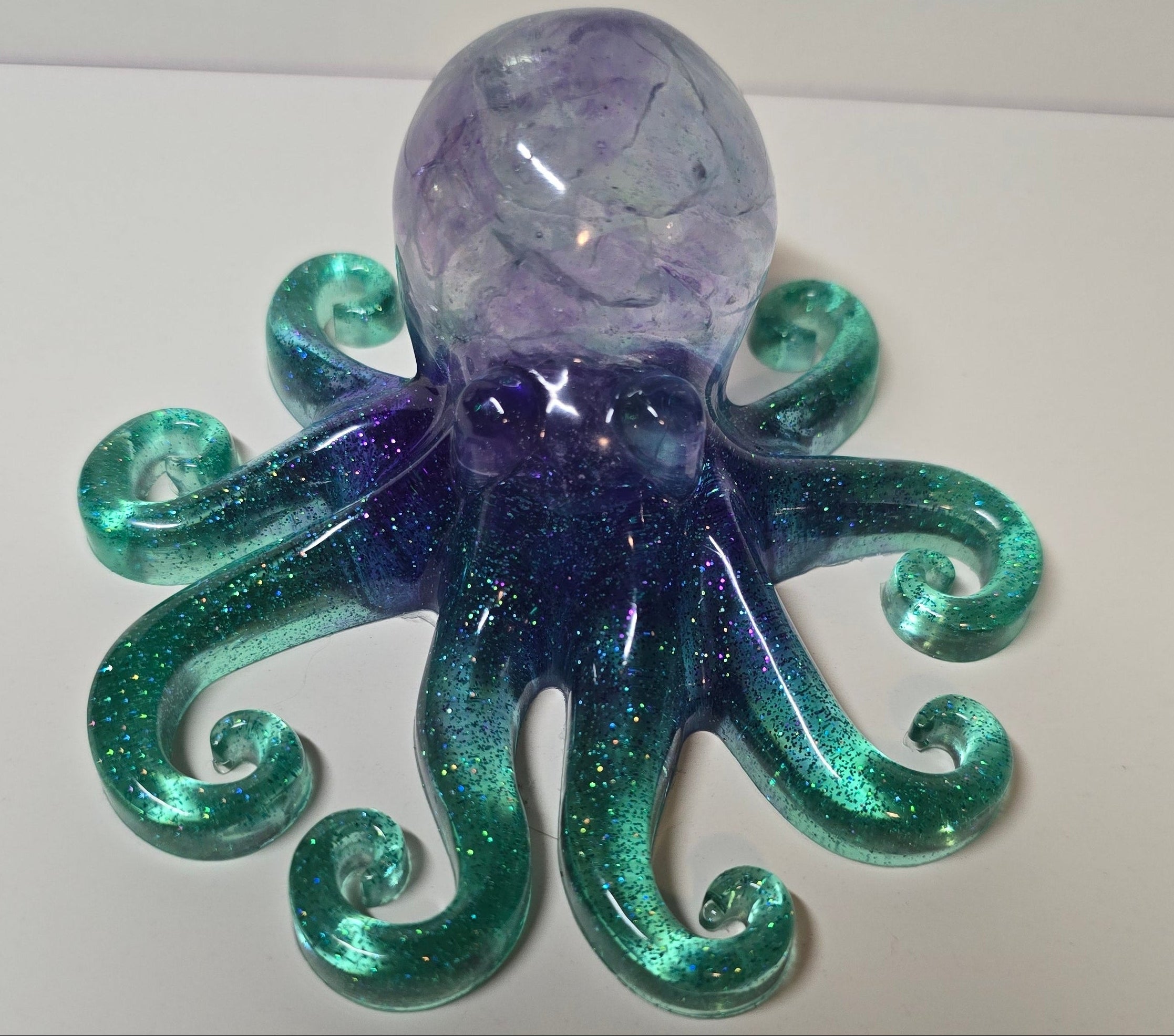 Beautiful octopus with purple mosaic glass rocks