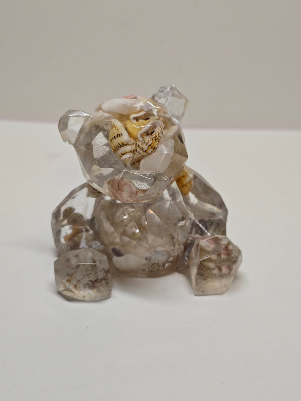 Bear figurine with seashells