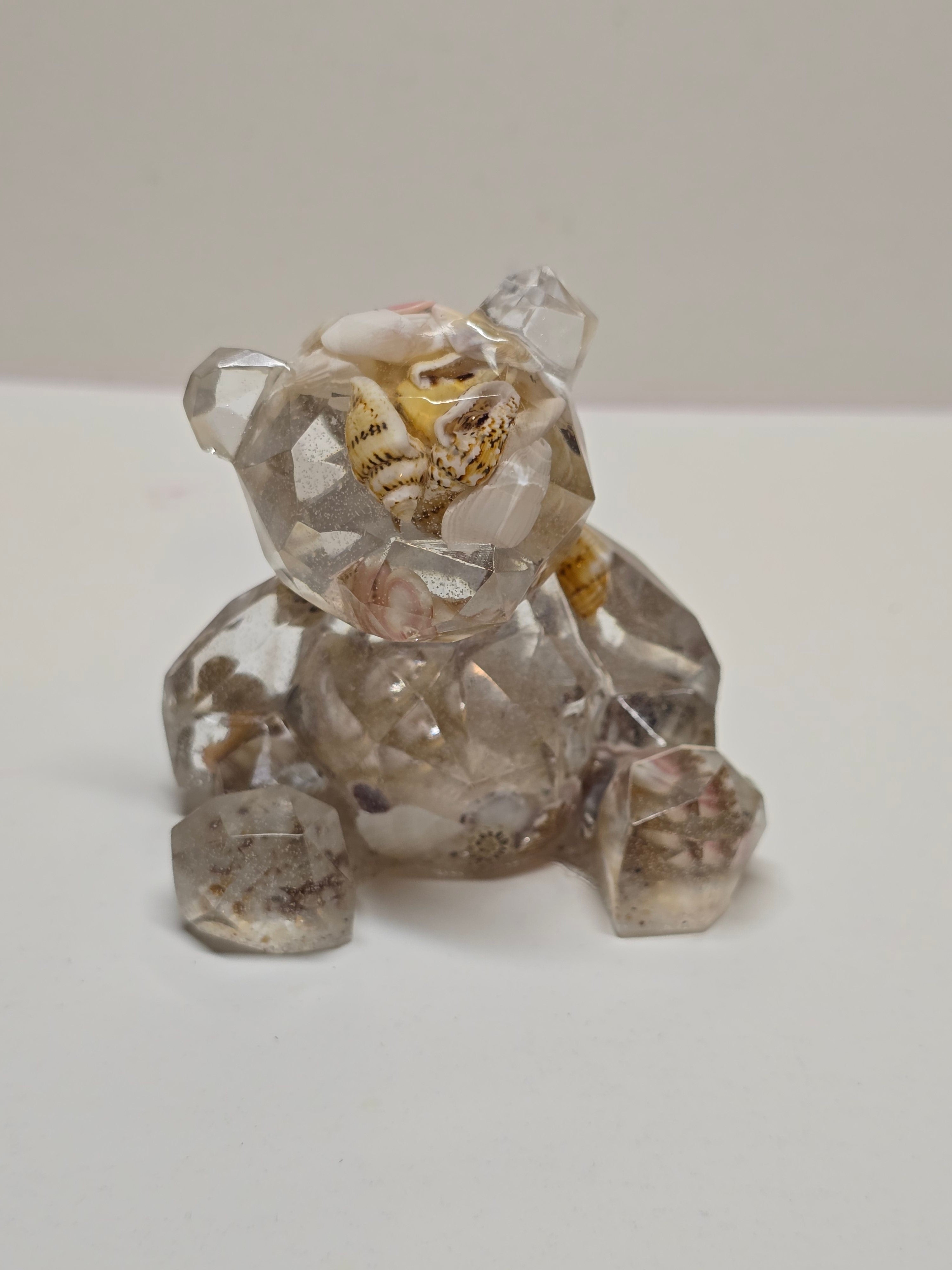Bear figurine with seashells