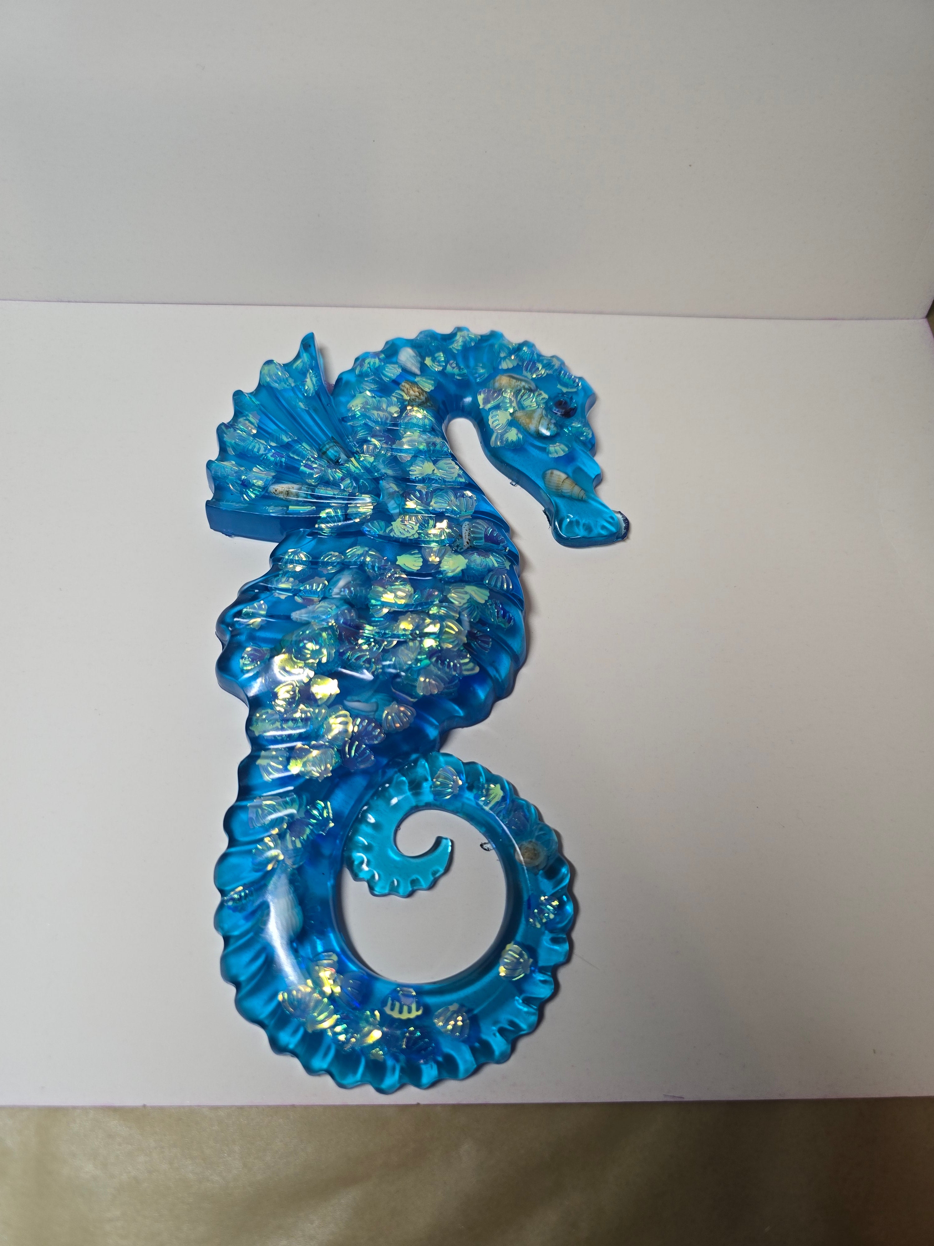 Blue transparent seahorse with seashells